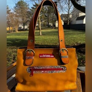 Rare lars tetens leather handbag in yellow/tan with a patterned zipper pouch